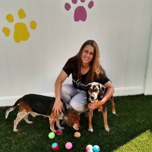 Karen playing ball with the pups